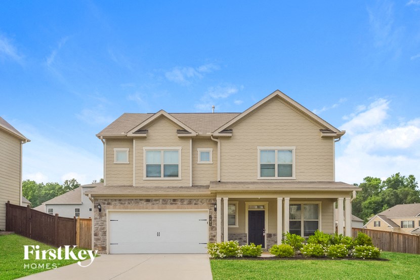 a beige house with a white garage door