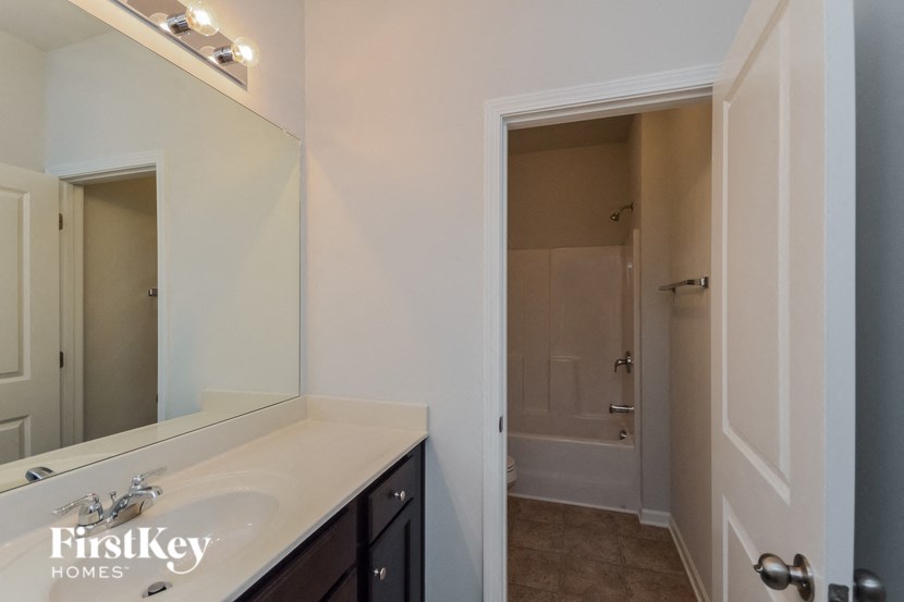 a bathroom with a sink and a mirror and a shower