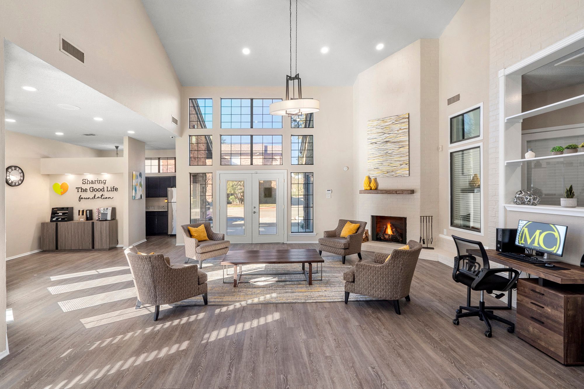 a living room with couches and chairs and a fireplace