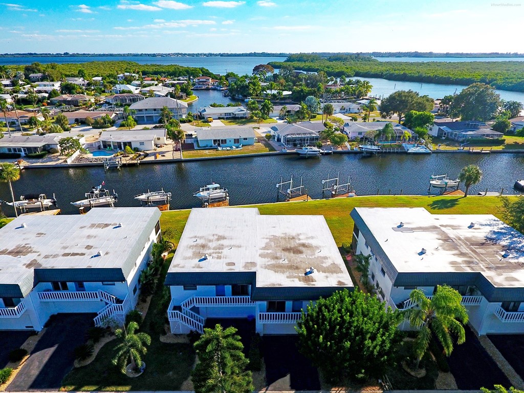 an aerial view of a marina with houses and boats on the water
