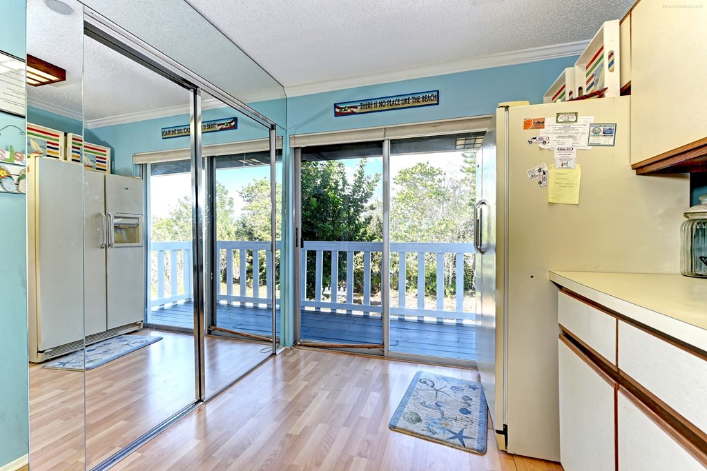 a kitchen with sliding glass doors to a balcony