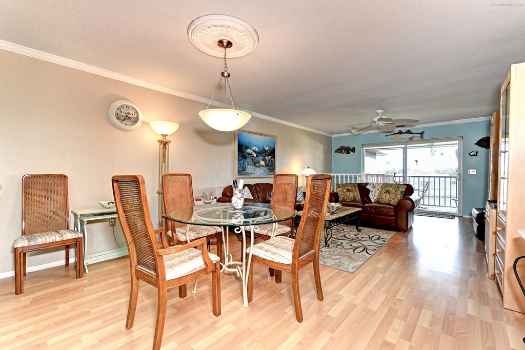 a dining room with a glass table and chairs