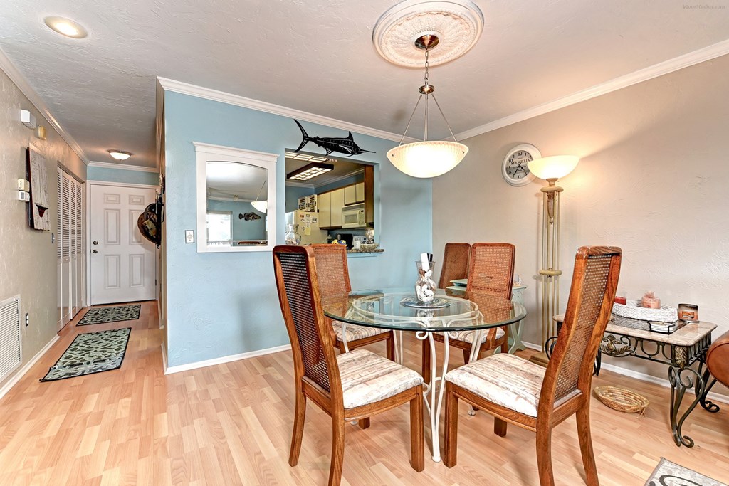 a dining room with a glass table and chairs