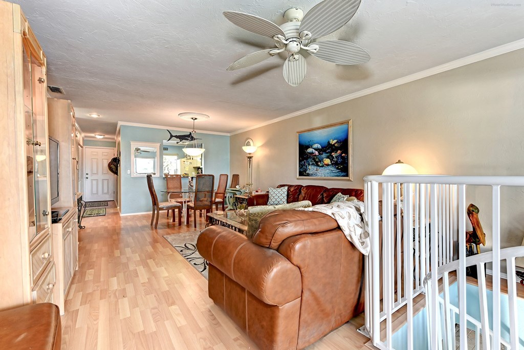 the living room is open to the dining room and kitchen