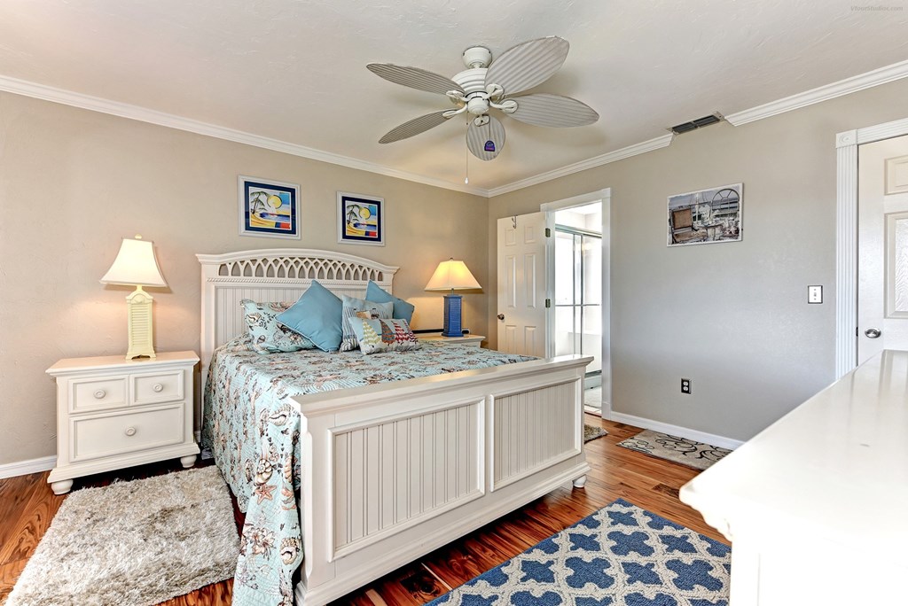 a bedroom with a bed and a ceiling fan