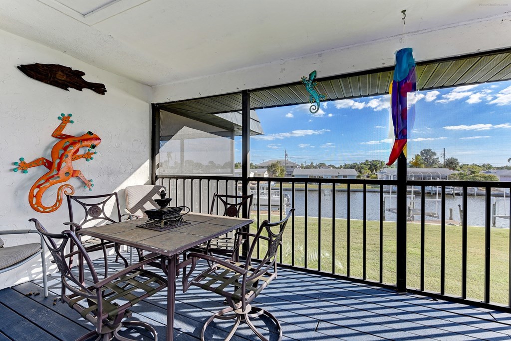 a patio with a table and chairs on a balcony