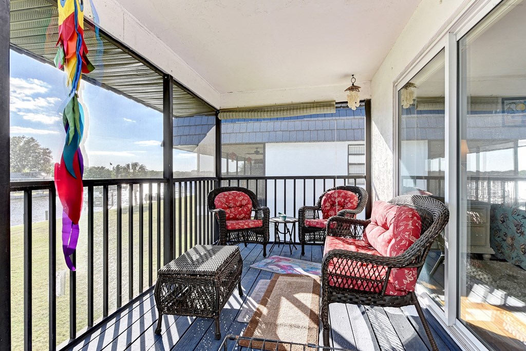 a patio with chairs and a table on a balcony