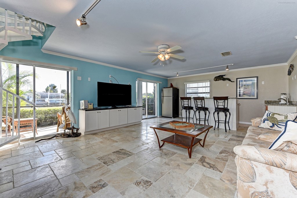 the living room is open to the dining room and the balcony
