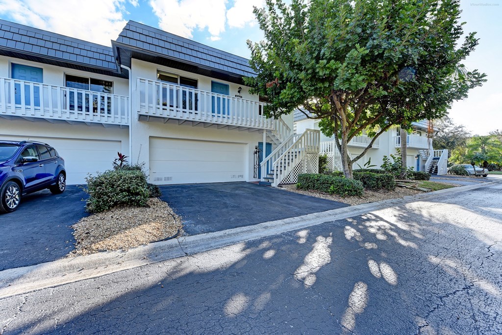 a white house with a car parked in front of it