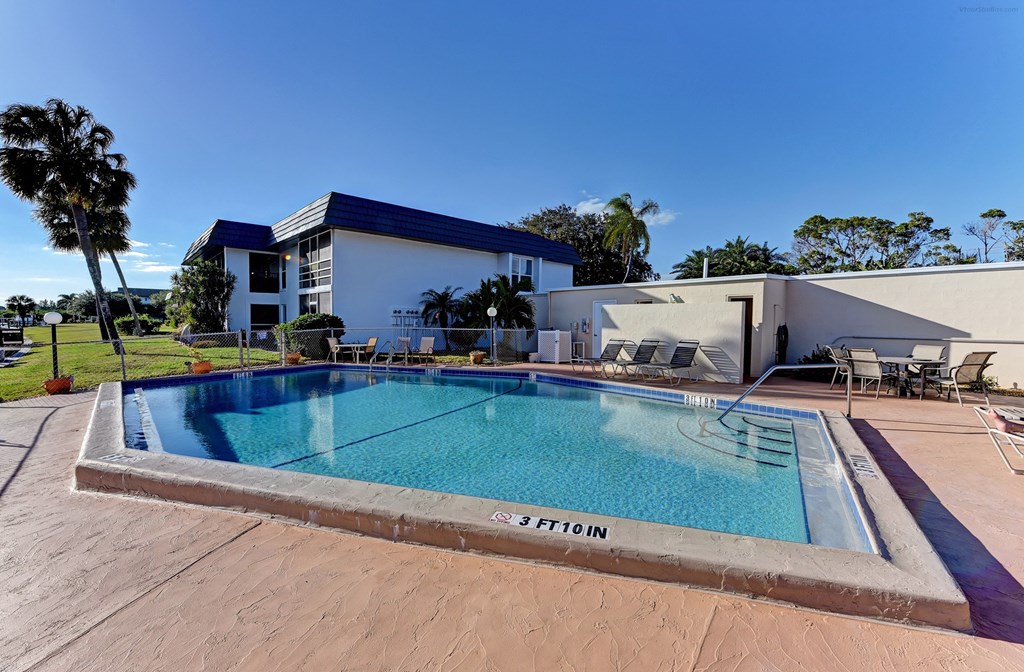 a swimming pool with a building in the background