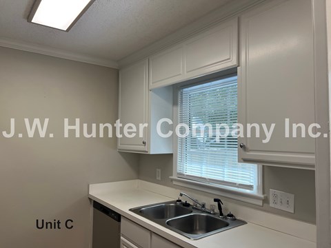 A kitchen with a sink and a window.