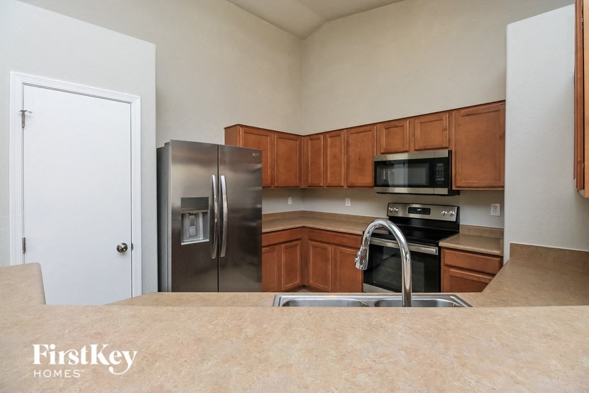 a kitchen with stainless steel appliances and wooden cabinets