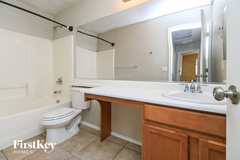 a bathroom with a sink toilet and a mirror