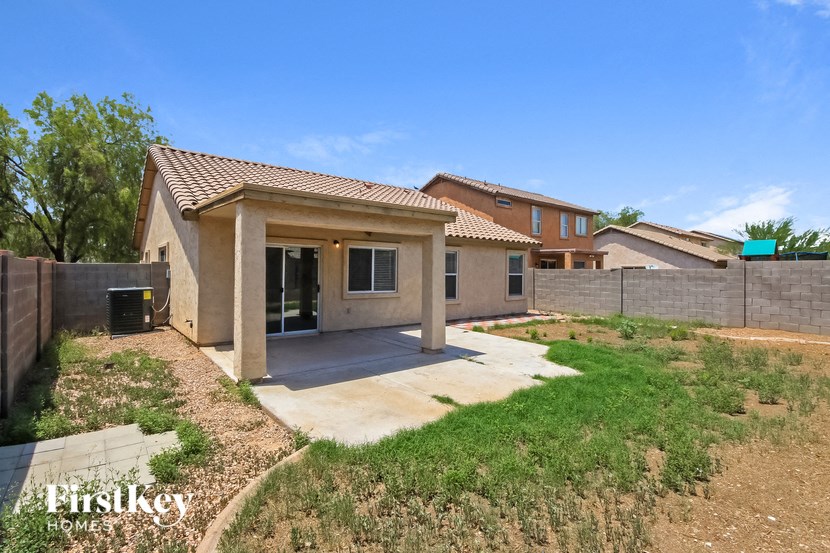a house with a patio and a yard in front of it