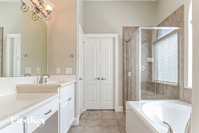 a bathroom with a tub sink and a shower