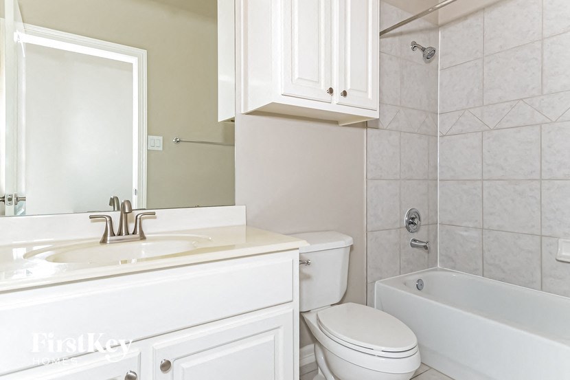 a bathroom with a sink toilet and a bath tub