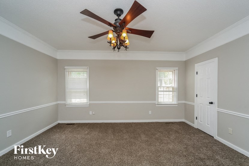 the living room of a home with a ceiling fan