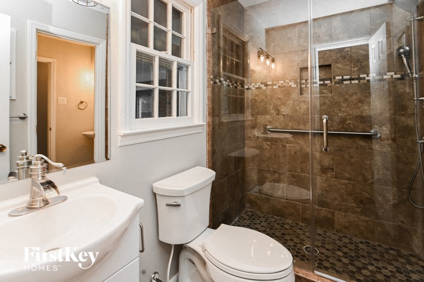 a bathroom with a toilet and a shower and a sink