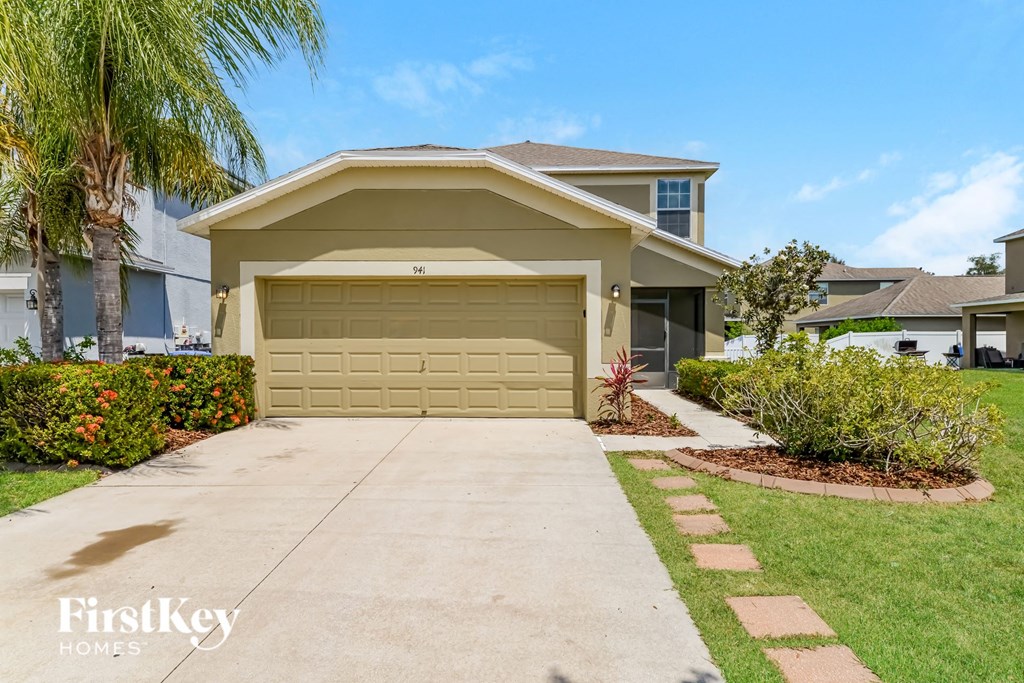 a beige garage door in front of a house