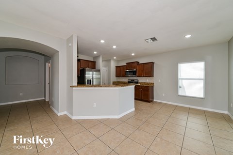 a large kitchen with a large counter top and a sink