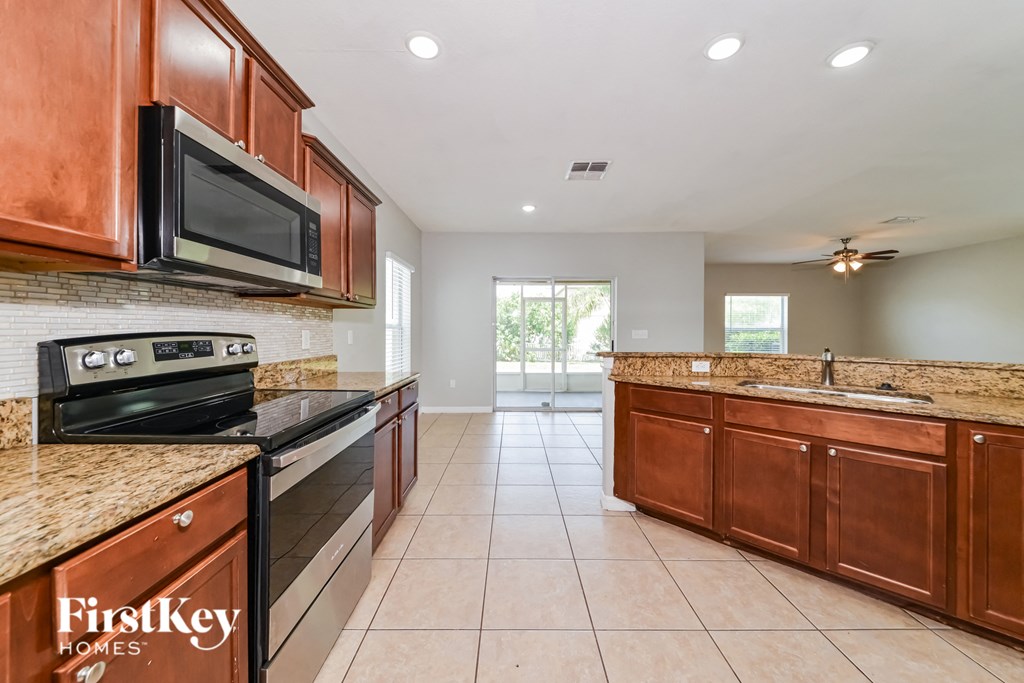 a kitchen with wooden cabinets and stainless steel appliances
