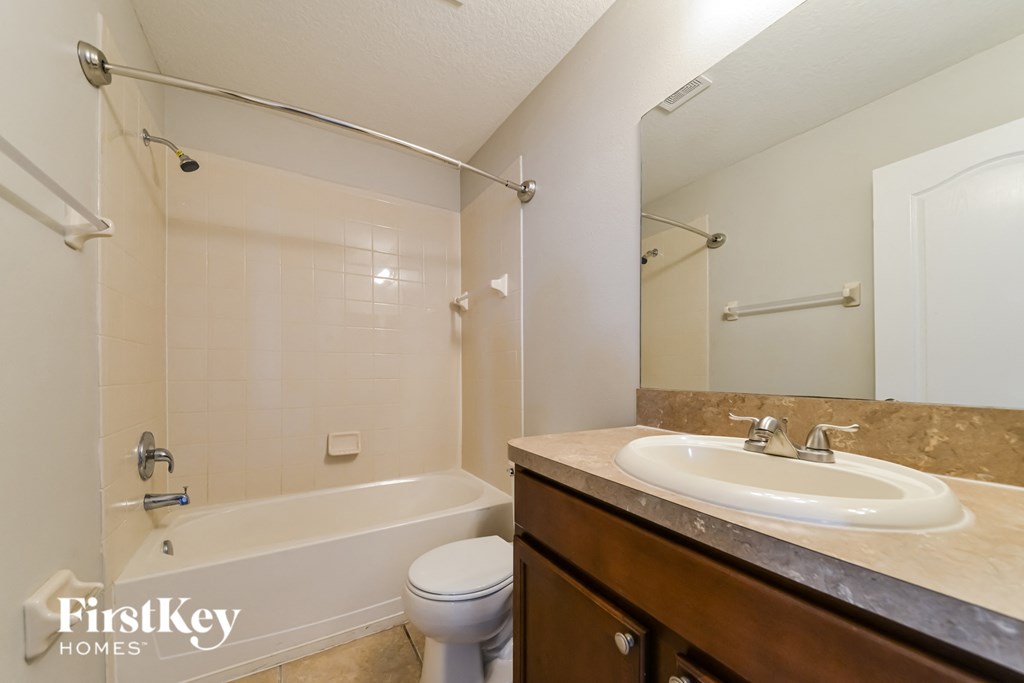 a bathroom with a sink and a toilet and a bath tub