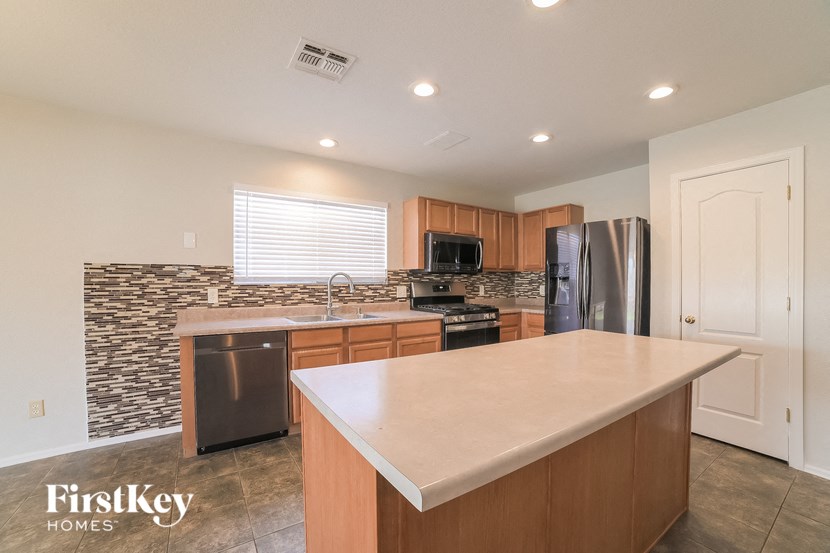 a kitchen with an island and stainless steel appliances