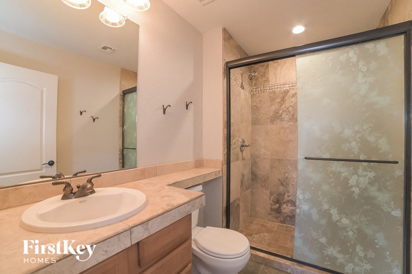 a bathroom with a sink toilet and a shower