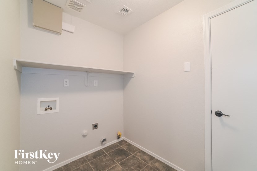 a small bathroom with a white wall and a door