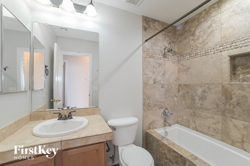 a bathroom with a sink toilet and a bath tub