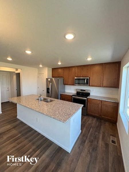A kitchen with wooden cabinets and a granite countertop.
