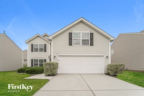 a white house with a sidewalk in front of it