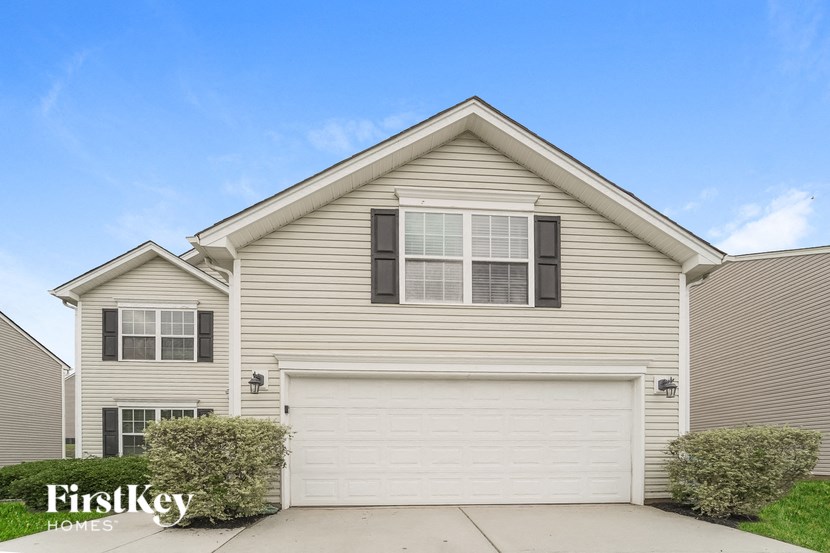 a white house with a white garage door