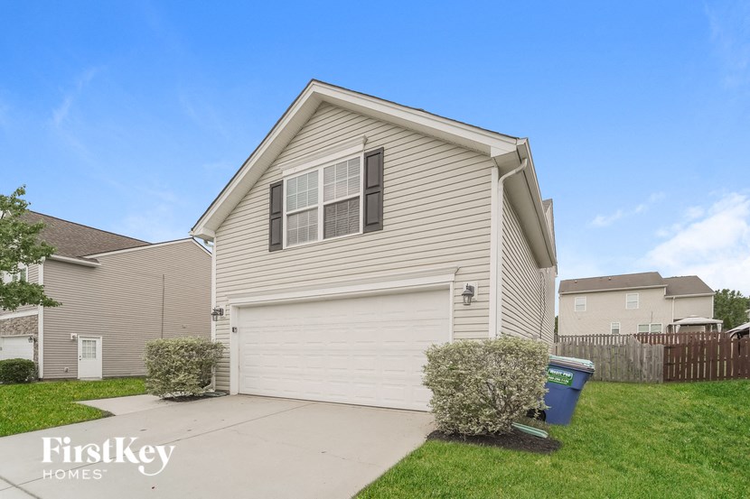 a house with a white garage door and a yard