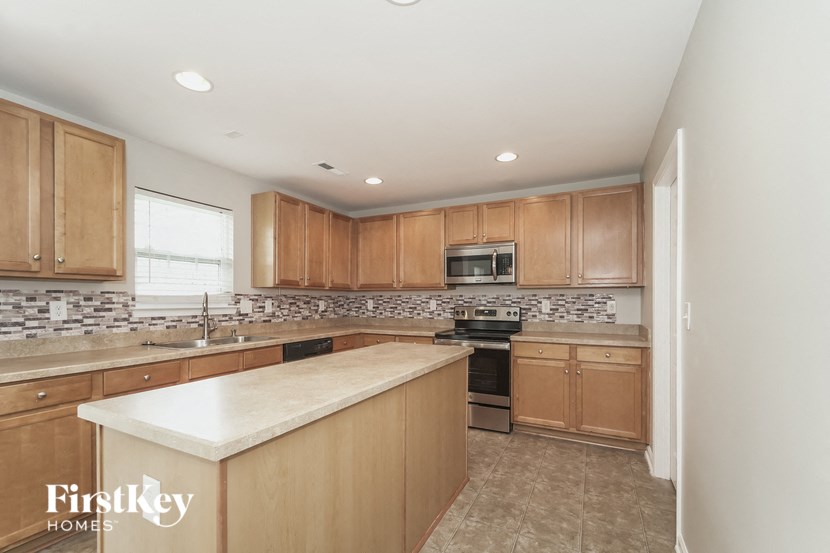 a kitchen with wooden cabinets and a counter top