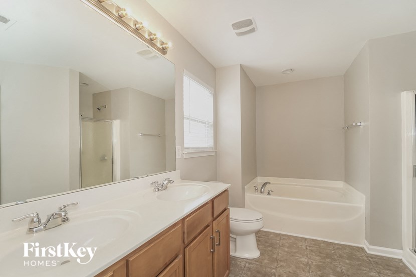 a bathroom with a sink toilet and a bath tub