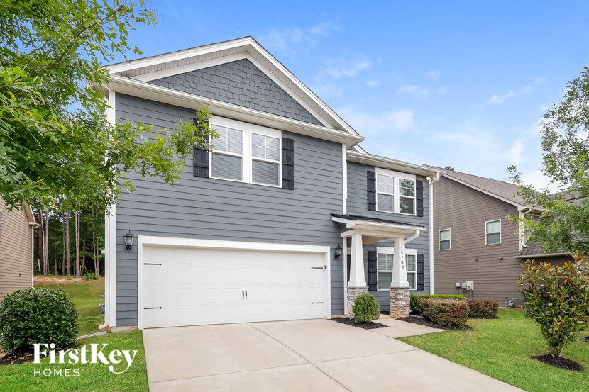 a gray house with a white garage door