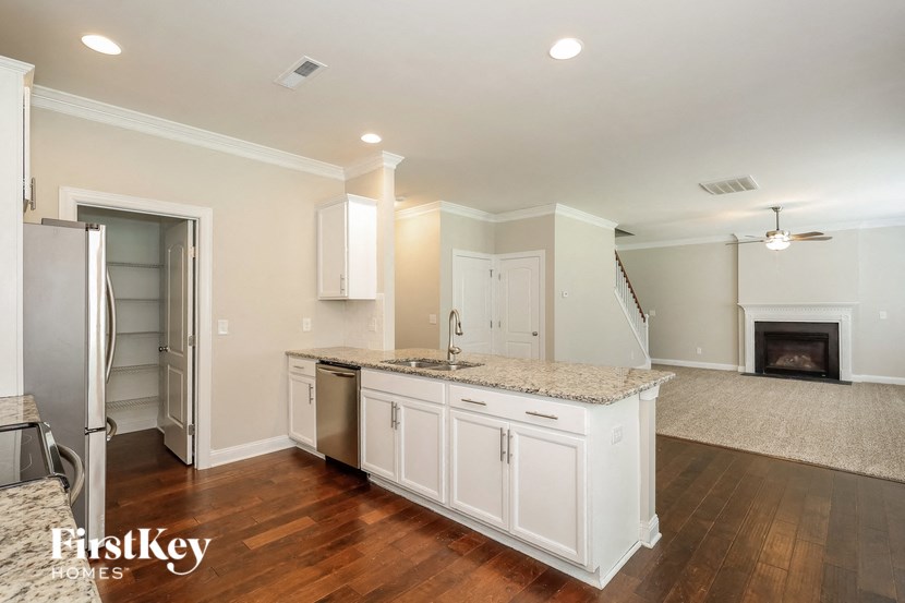 a kitchen with white cabinets and a counter top