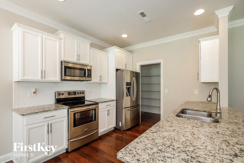 a kitchen with granite counter tops and stainless steel appliances