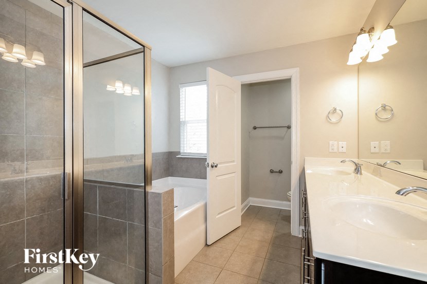 a bathroom with a shower and a sink and a mirror