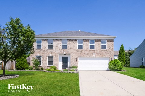 a brick house with a white garage door