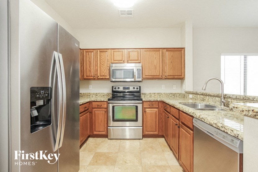 a kitchen with stainless steel appliances and wooden cabinets