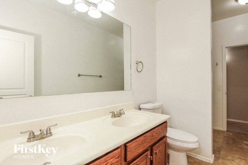 a bathroom with a sink and a toilet and a mirror