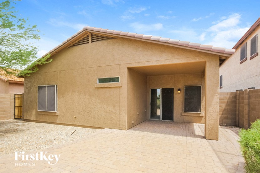 a brown house with a driveway and a door