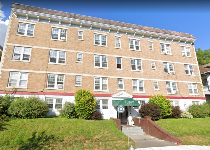 a large brick building with stairs in front of it
