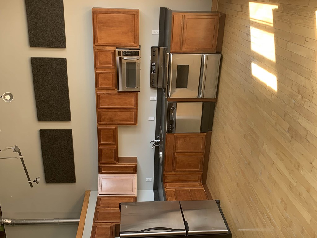 a kitchen with wooden cabinets and stainless steel appliances