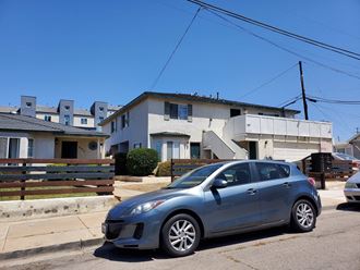 a car parked on the street in front of a house