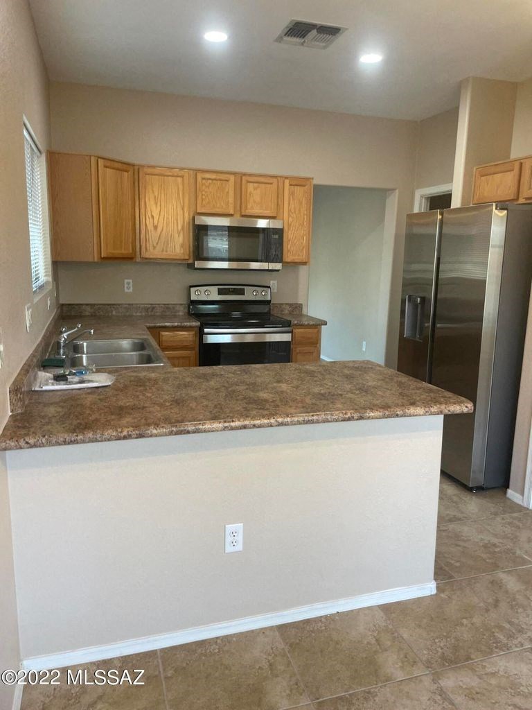 a kitchen with stainless steel appliances and a granite counter top