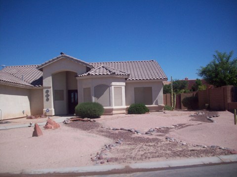 A house with a brown roof and a white door.