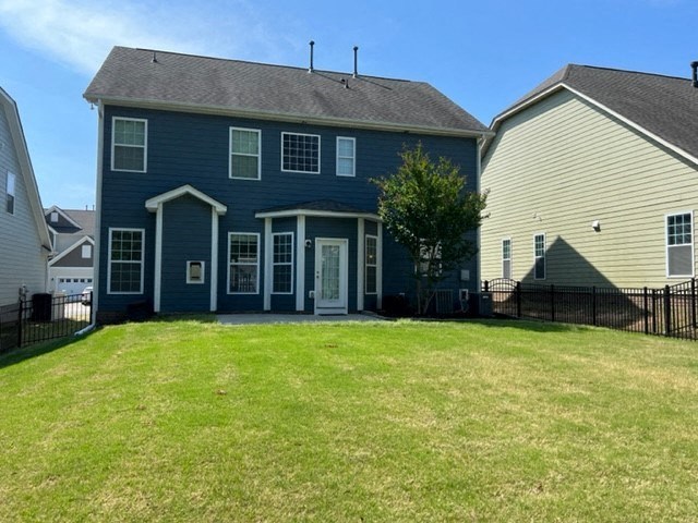 a blue house with a yard in front of it